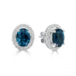 Oval London blue topaz with round diamond halo studs