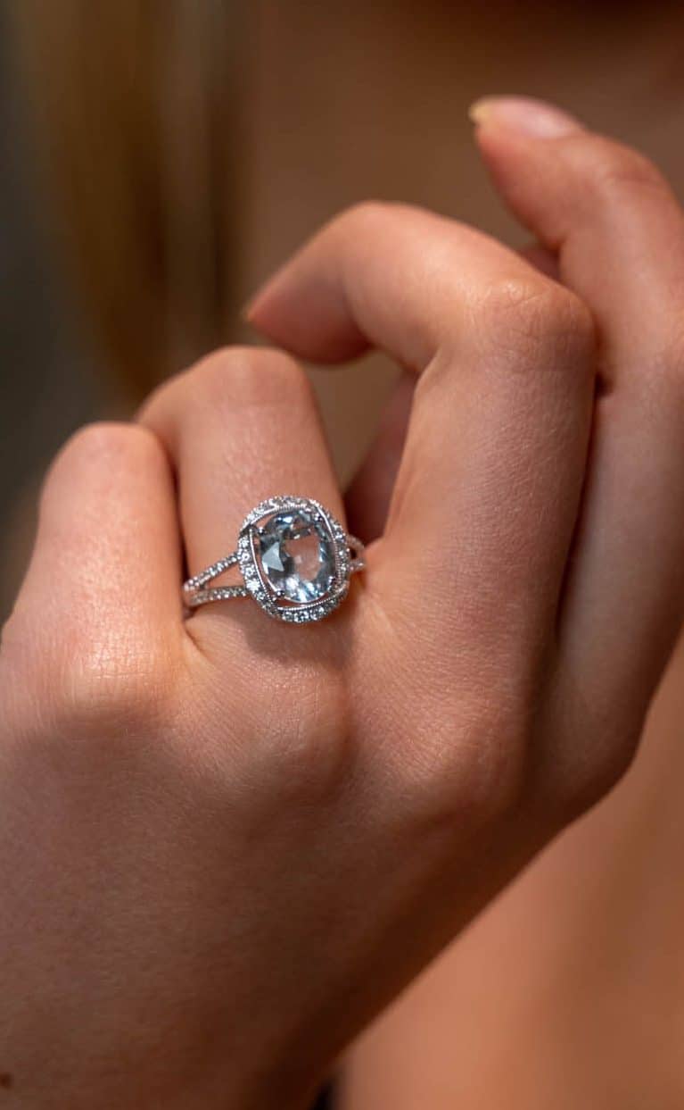 Oval cut Aquamarine and diamond halo ring